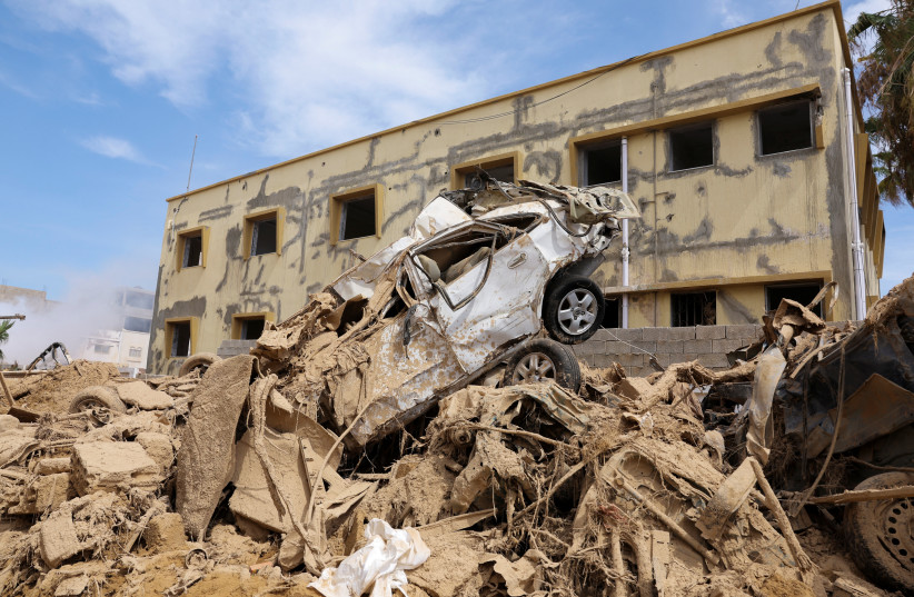  A destroyed car sits on top of a pile of rubble, following fatal floods in Derna, Libya, September 17, 2023REUTERS/Amr Alfiky (photo credit: REUTERS/AMR ALFIKY)