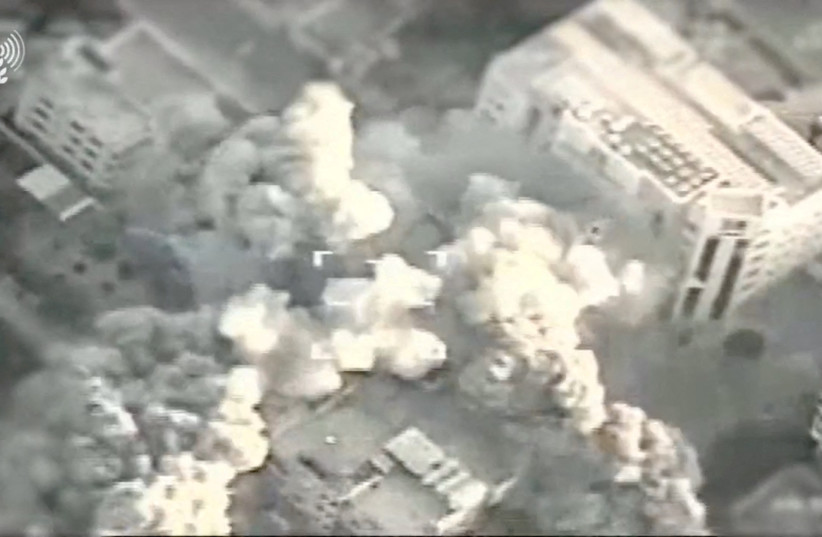  A view of an explosion following a strike by IDF fighter jets on Hamas targets at a location given as the Gaza Strip, in this screengrab taken from a handout video released on October 13, 2023. (photo credit: Israel Defense Forces/Handout via REUTERS)