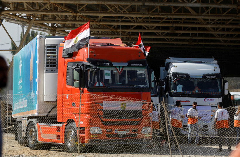 Trucks carrying aid arrive at the Palestinian side of the border with Egypt, as the conflict between Israel and Palestinian terrorist group Hamas continues, in Rafah in the southern Gaza Strip, October 21, 2023. (photo credit: REUTERS/Ibraheem Abu Mustafa)