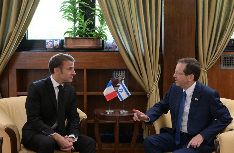 French President Emmanuel Macron meets with Israeli President Isaac Herzog, during the former's one-day visit to Israel, October 24, 2023 (photo credit: AMOS BEN-GERSHOM/GPO)