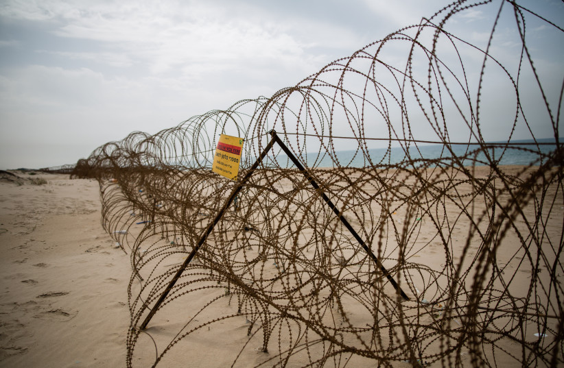  A barbed wire fence is seen on Zikim beach, in southern Israel near the border with Northern Gaza Strip, on April 5, 2016 (photo credit: CORINNA KERN/FLASH90)