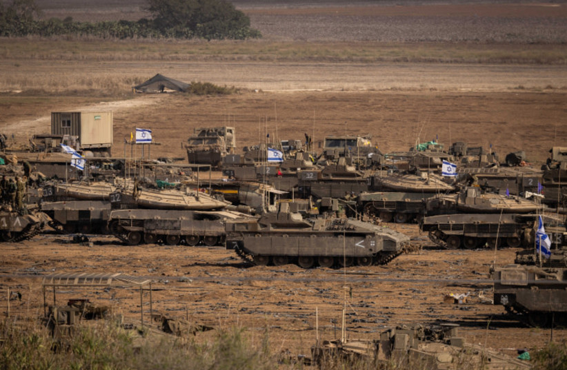 Israeli soldiers at a staging area near the Israeli-Gaza border, October 24, 2023 (photo credit: YONATAN SINDEL/FLASH90)