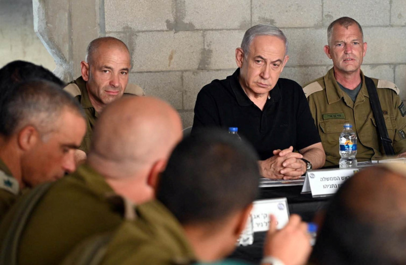  Israeli Prime Minister Benjamin Netanyahu meets with soldiers as he visits an Israeli army base in Tze'elim, Israel November 7, 2023. (photo credit: Israeli Government Press Office/Haim Zach/Handout via REUTERS)