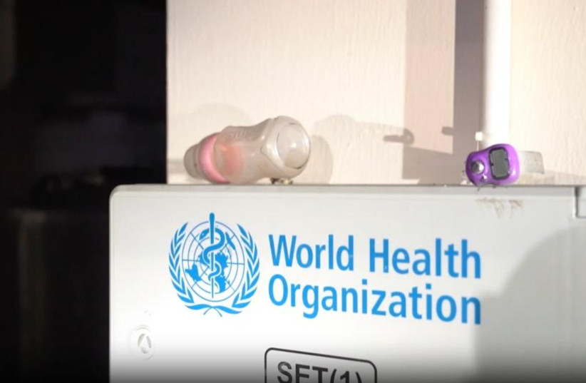 A baby bottle is seen atop a piece of medical equipment with the World Health Organization's logo, in a Hamas command center that Israeli military forces discovered under the Rantisi children's hospital in Gaza City, on November 13, 2023. (photo credit: IDF SPOKESPERSON'S UNIT)