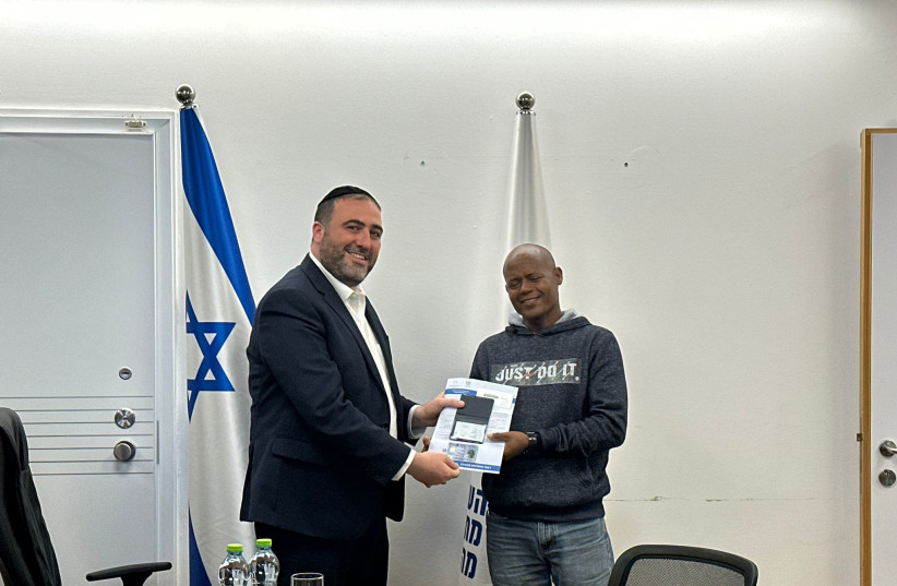  Minister of the Interior Moshe Arbel with Eritrean citizen Molugata Tsagai, who saved the life of an IDF officer on October 7. As a token of gratitude, Arbel had the Ministry grant residency status to Tsagai. November 26, 2023. (photo credit: COURTESY INTERIOR MINISTRY)