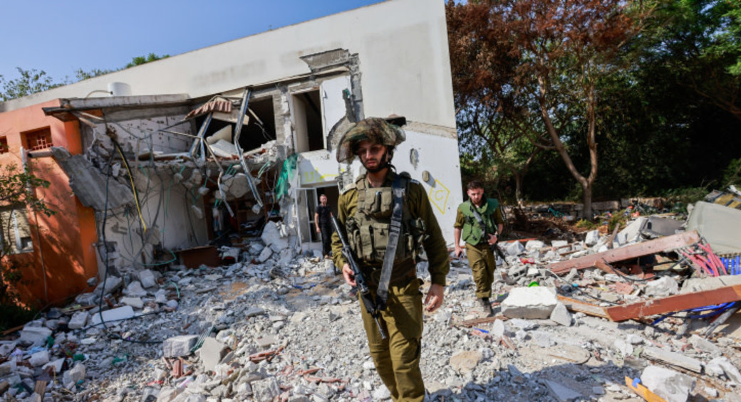 Israeli soldiers around the destruction caused by Hamas terrorists when they infiltrated Kibbutz Be'eri, near the Israeli-Gaza border, southern Israel. October 25, 2023 (photo credit: YOSSI ZAMIR/FLASH90)