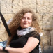 Ahed Tamimi next to a large Palestinian monument 