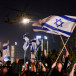 People wave Israeli flags as a helicopter, carrying hostages, departs from Schneider Children's Medical Center in Petah Tikva, Israel, November 24, 2023