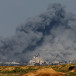  Smoke rises among buildings destroyed in IDF airstrikes, amid the ongoing war between Israel and Hamas, at the Israel-Gaza border as seen from southern Israel, December 6, 2023.