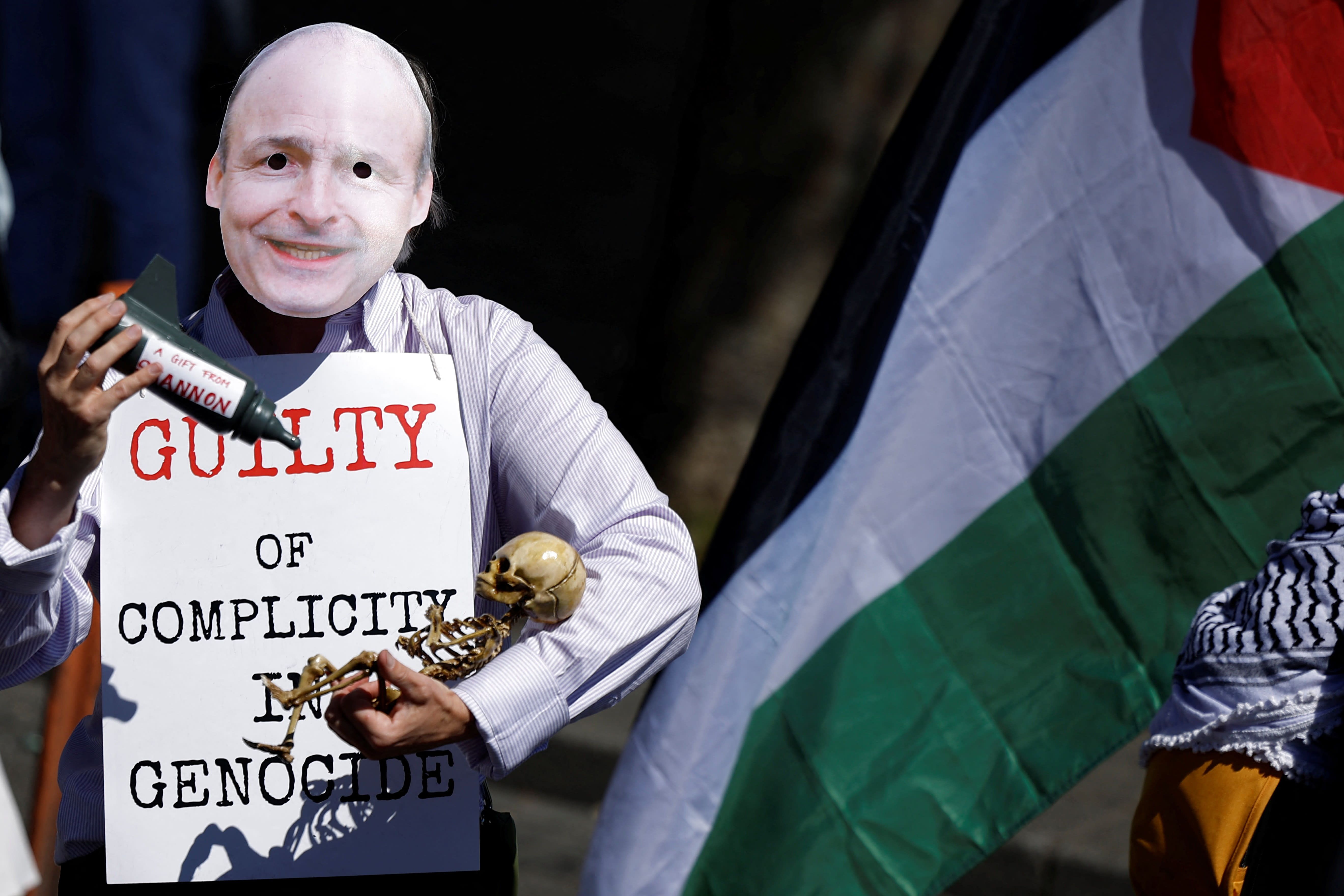 A man wearing a mask depicting Ireland’s Taoiseach (Prime Minister) Micheal Martin holds a poster and props during a protest in support of Palestinians in Gaza to mark the 77th anniversary of the ''Nakba'', or ''catastrophe'', in Dublin, Ireland, May 17, 2025.