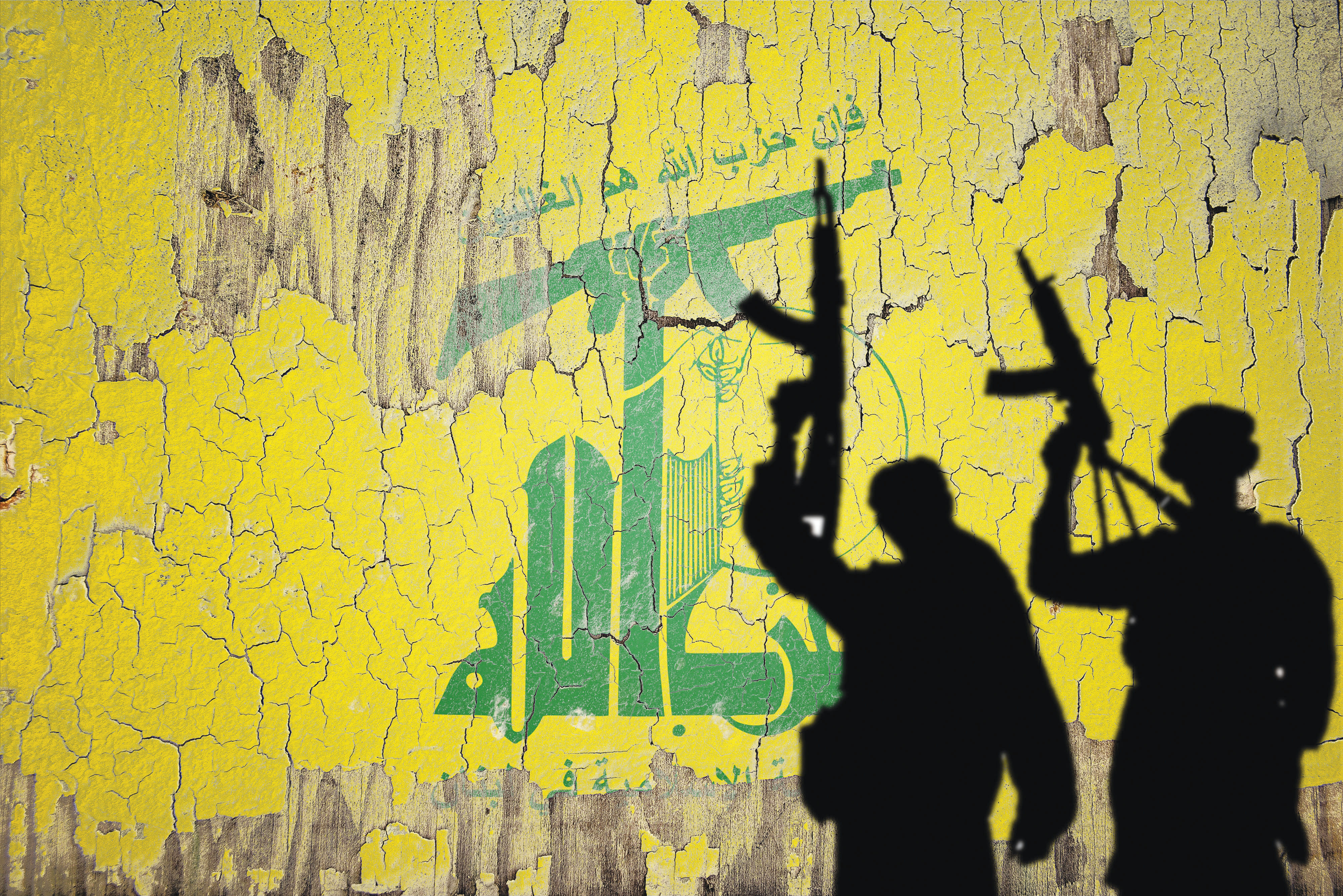 Hezbollah flag mural provides backdrop for gun-wielding shadows.