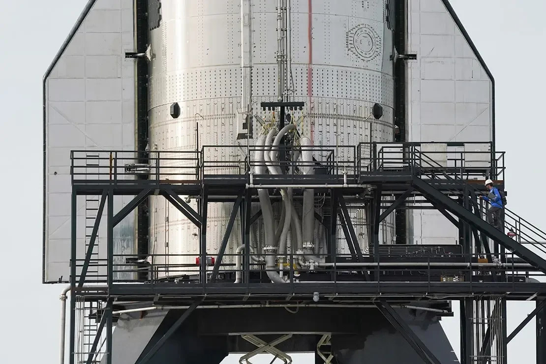 A SpaceX rocket towers above production standards outside of Brownsville