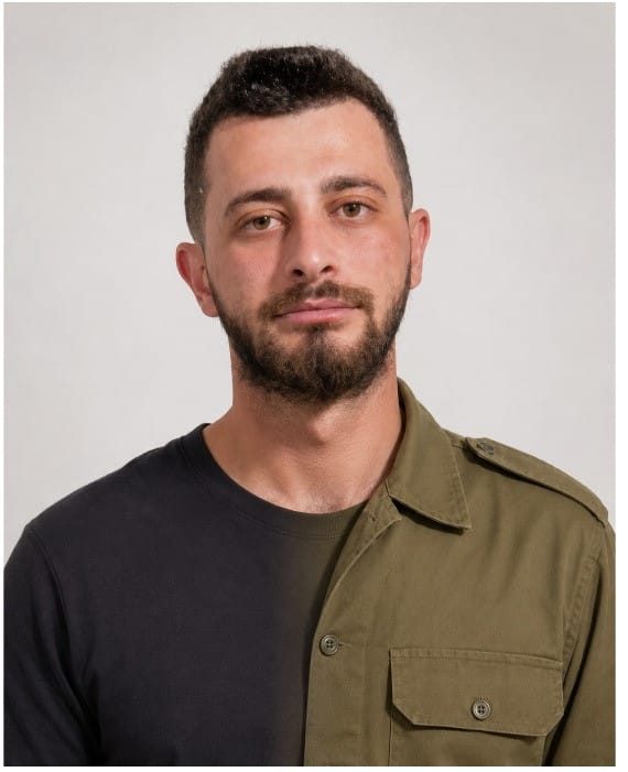 Chief Sgt. First Class (res.) Basil Sweid, half in civilian clothing and half in military uniform, as part of a campaign at Rambam Medical Center, Haifa, to honor their staff members serving in the military's reserves, June 2026.