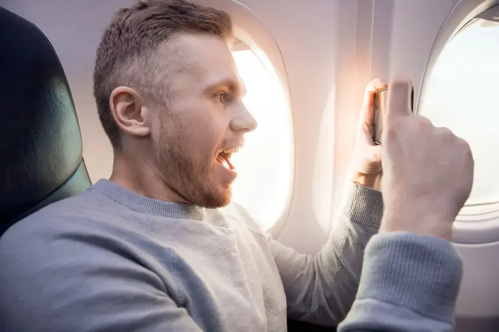 Want to watch videos on your cell phone during a flight? Do so only with headphones