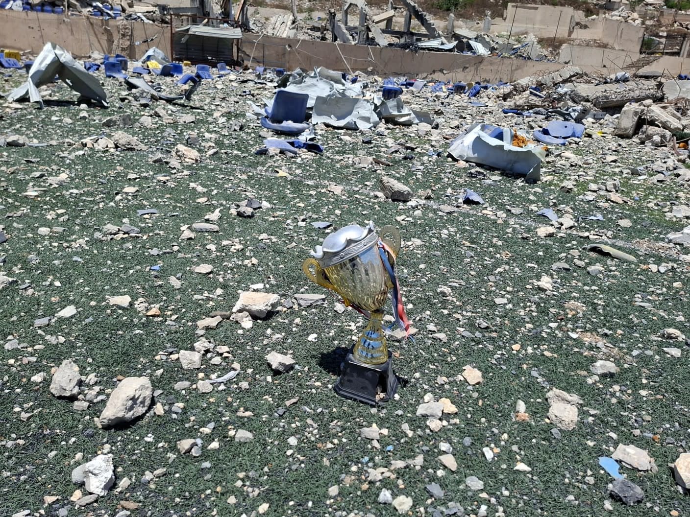 A broken trophy and other debris scattered across the Bint Jbail stadium, southern Lebanon, July 15, 2026.