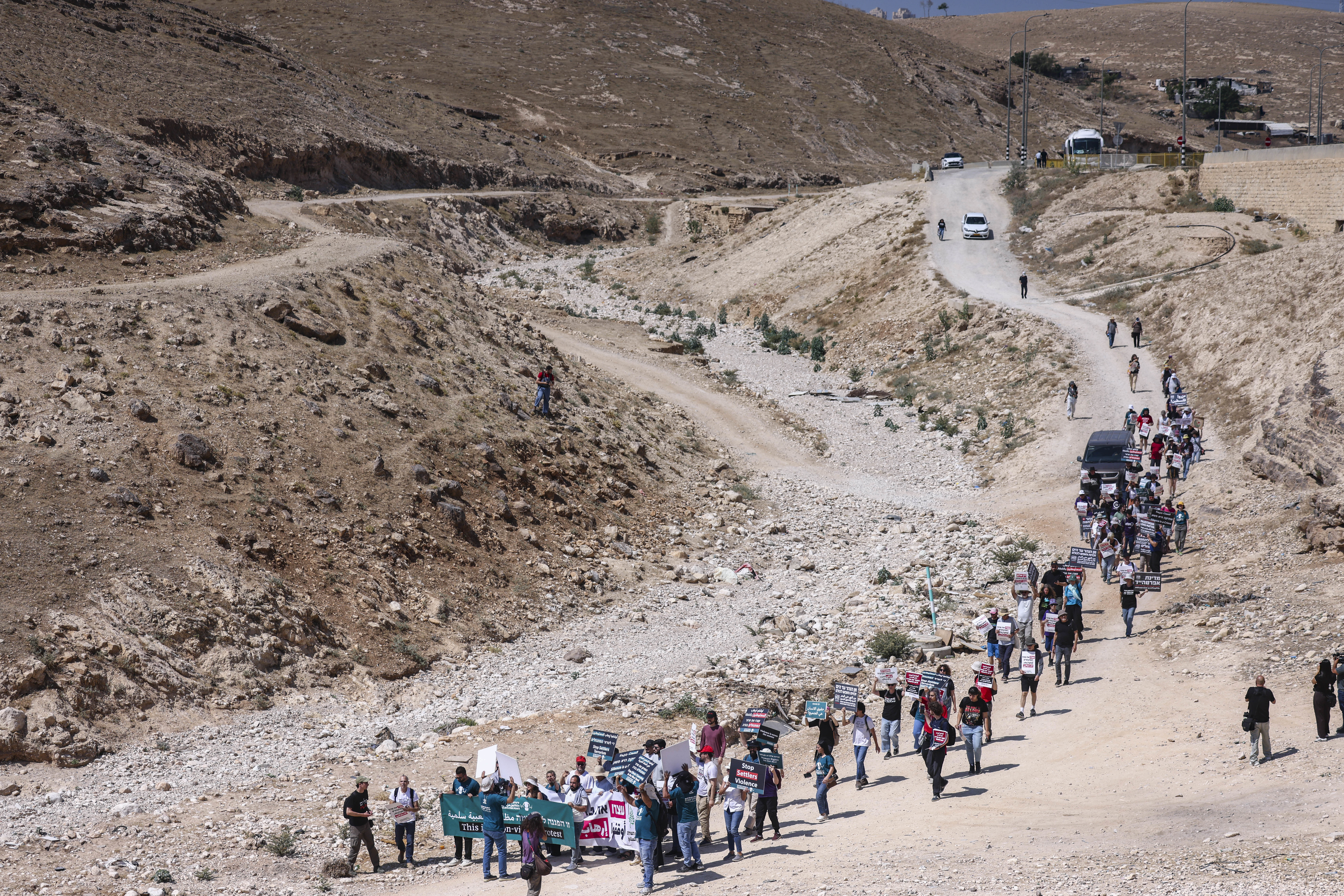 Israeli left-wing activists and Palestinians demonstrate against violence by extremist Israeli settlers in the West Bank, near the unrecognized Bedouin village of Khan al-Ahmar, east of Jerusalem, June 12, 2026.