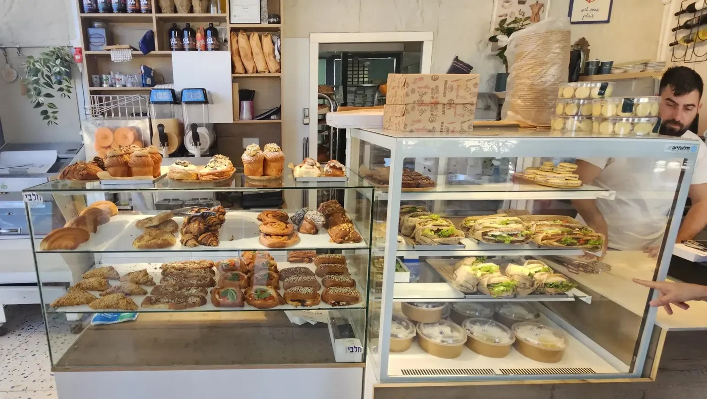 A display case loaded with pastries based on croissant dough, both sweet and savory.