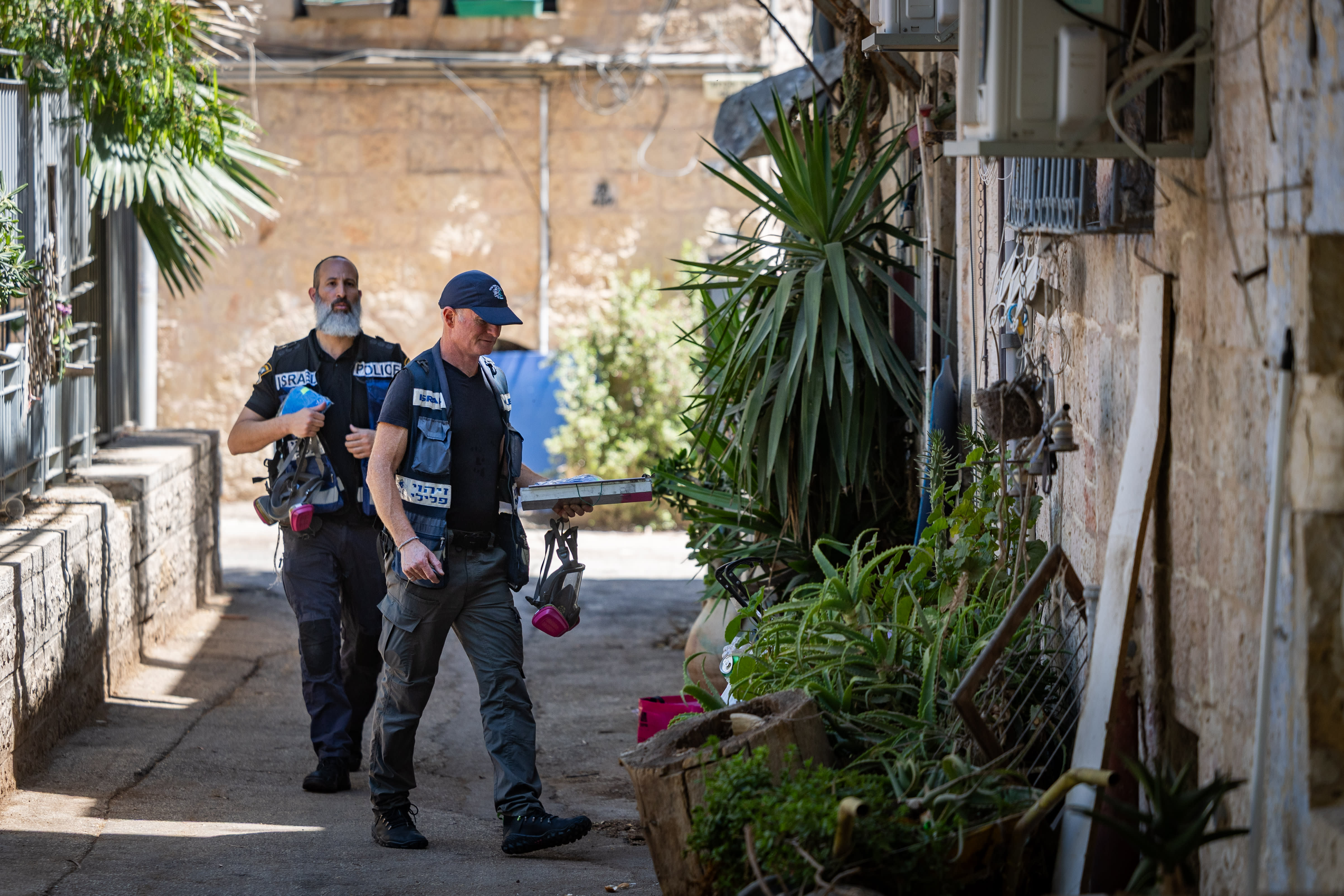 Police officers stand at the scene of last night’s murder of a 19-year-old man in the Nachlaot neighborhood of Jerusalem, July 12, 2026.