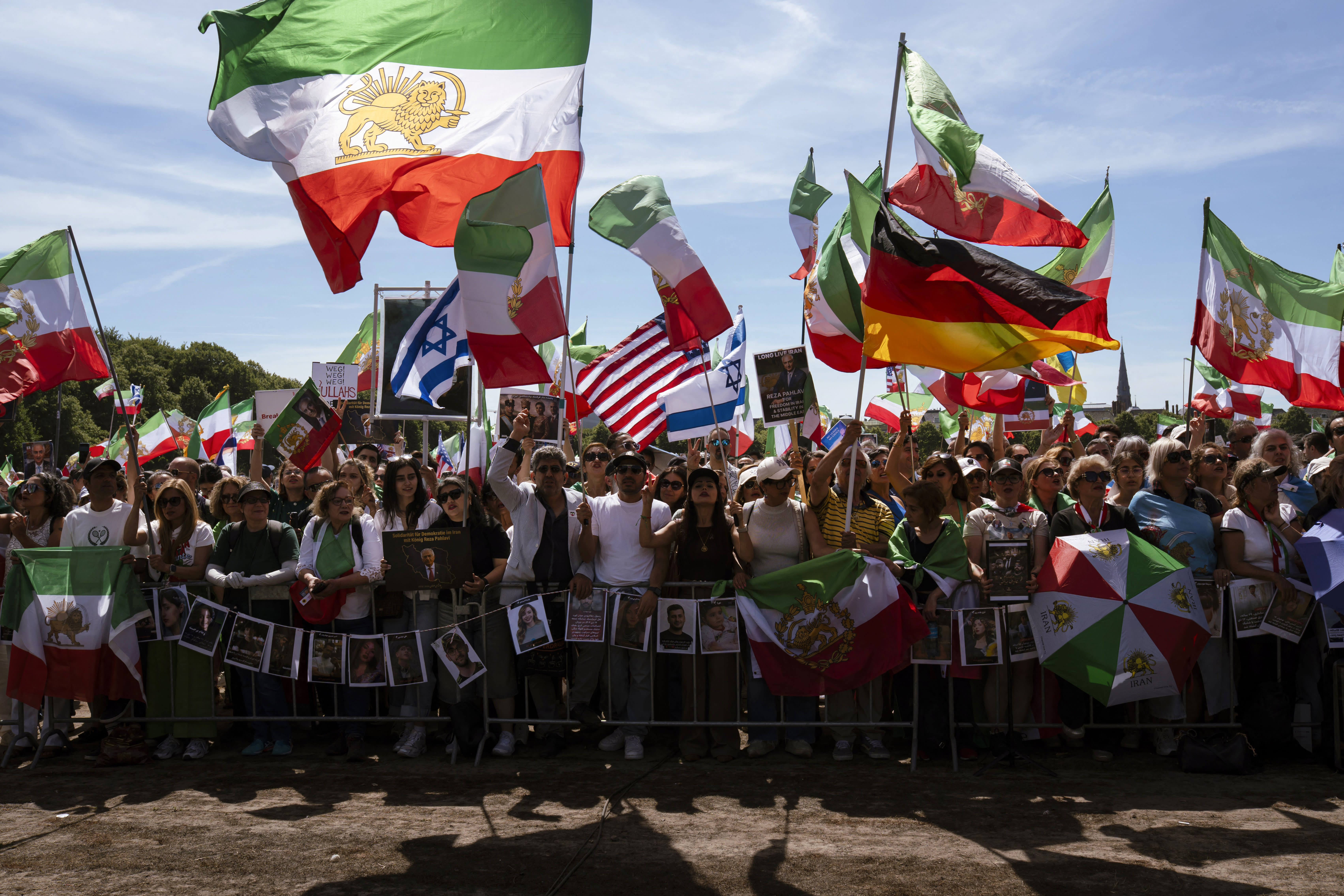 Demonstrators shout slogans and wave flags of Germany, Israel, US and Iran's pre-Islamic revolution of 1979 as they gather at the Malieveld Square in support of the son of Iran's last shah, Crown Prince Reza Pahlavi during his visit to Netherlands' Parliament in The Hague on July 6, 2026.