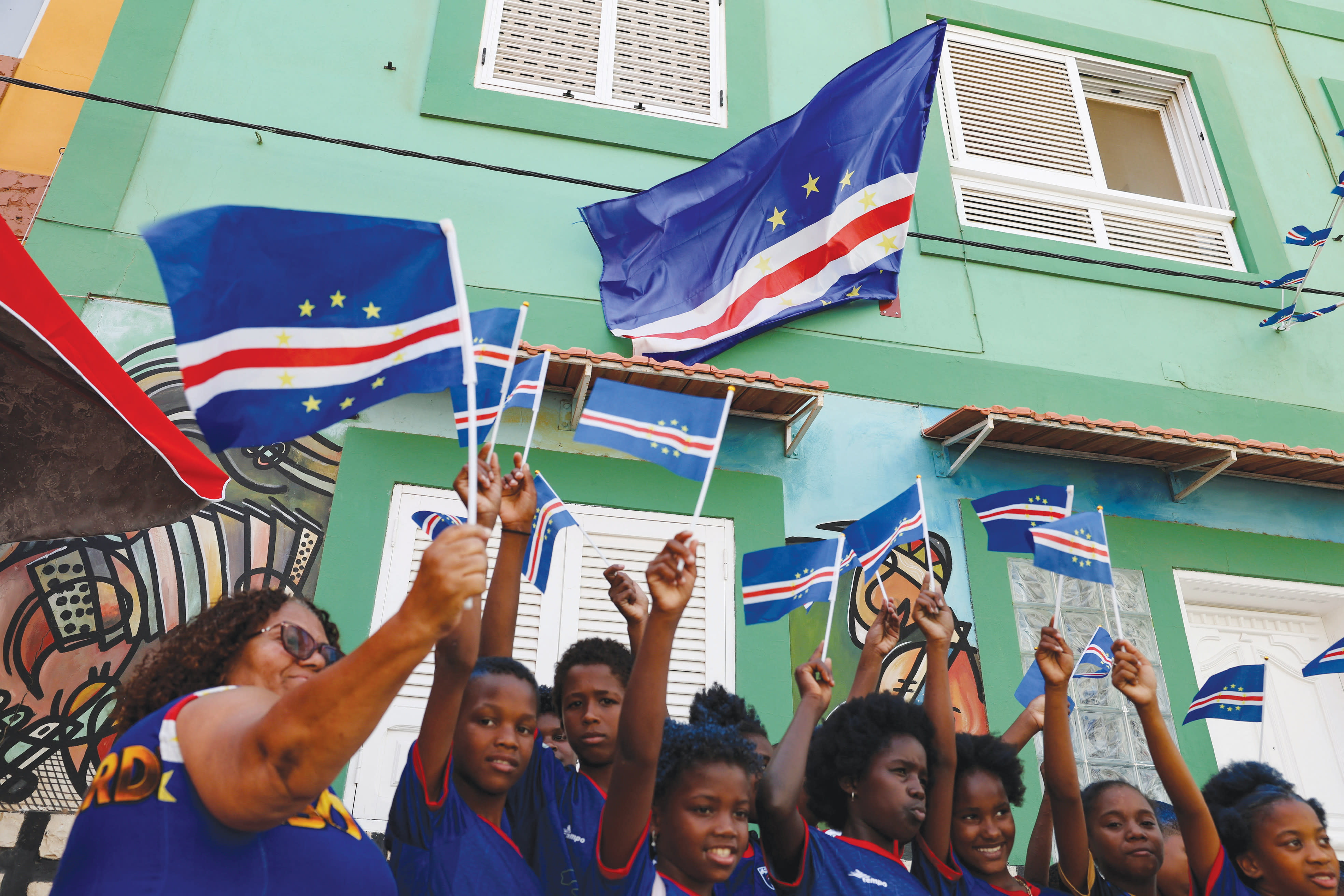 WAVING CAPE VERDE FLAGS ahead of the World Cup match between with Saudi Arabia, in Praia, Cape Verde, June 26.