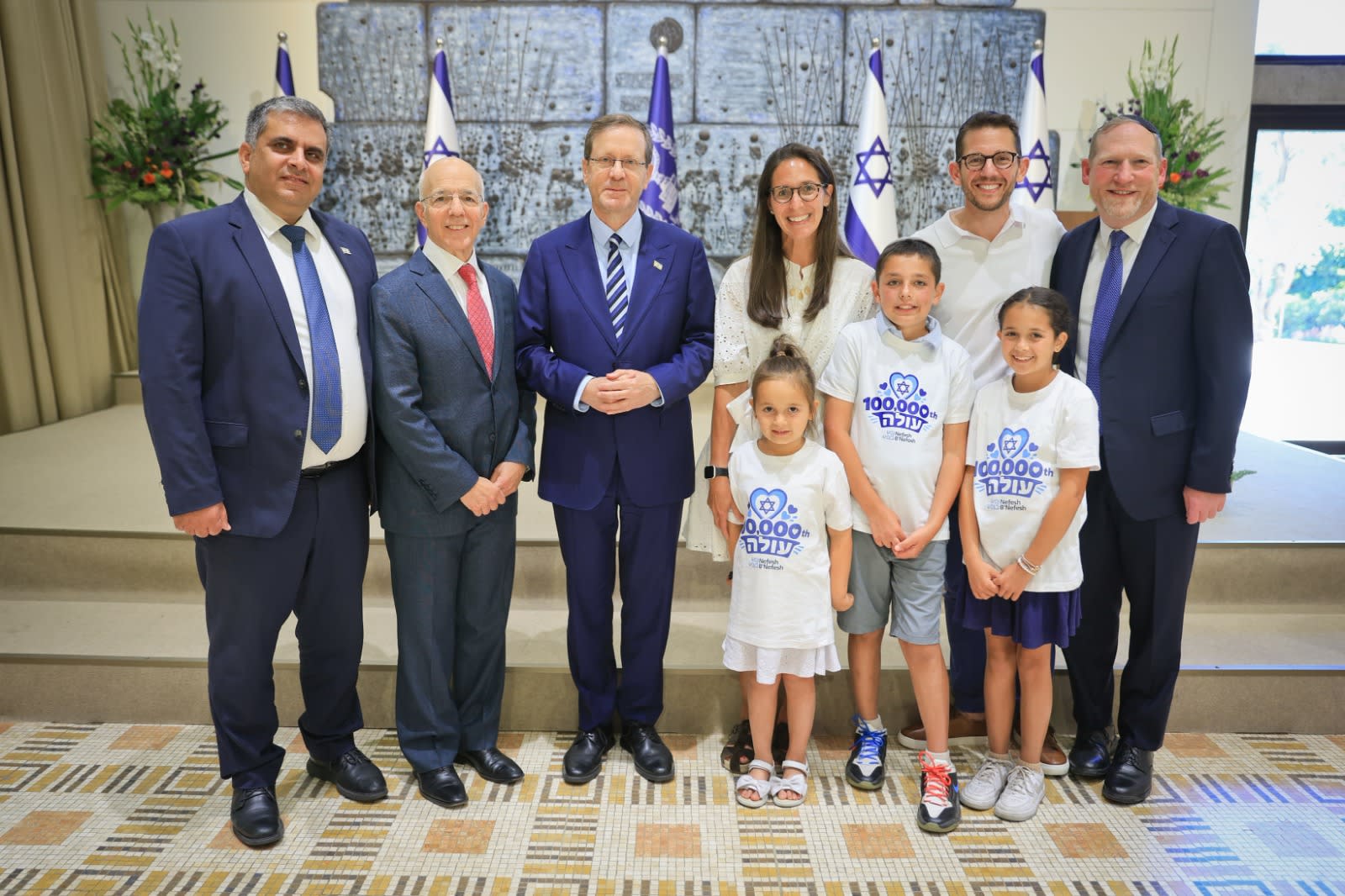 President Isaac Herzog, Aliyah and Integration Minister Ofir Sofer, Nefesh B'Nefesh founders Rabbi Yehoshua Fass and Tony Gelbart welcome the Douglas family in the President's Residence, Jerusalem, August 9, 2026.