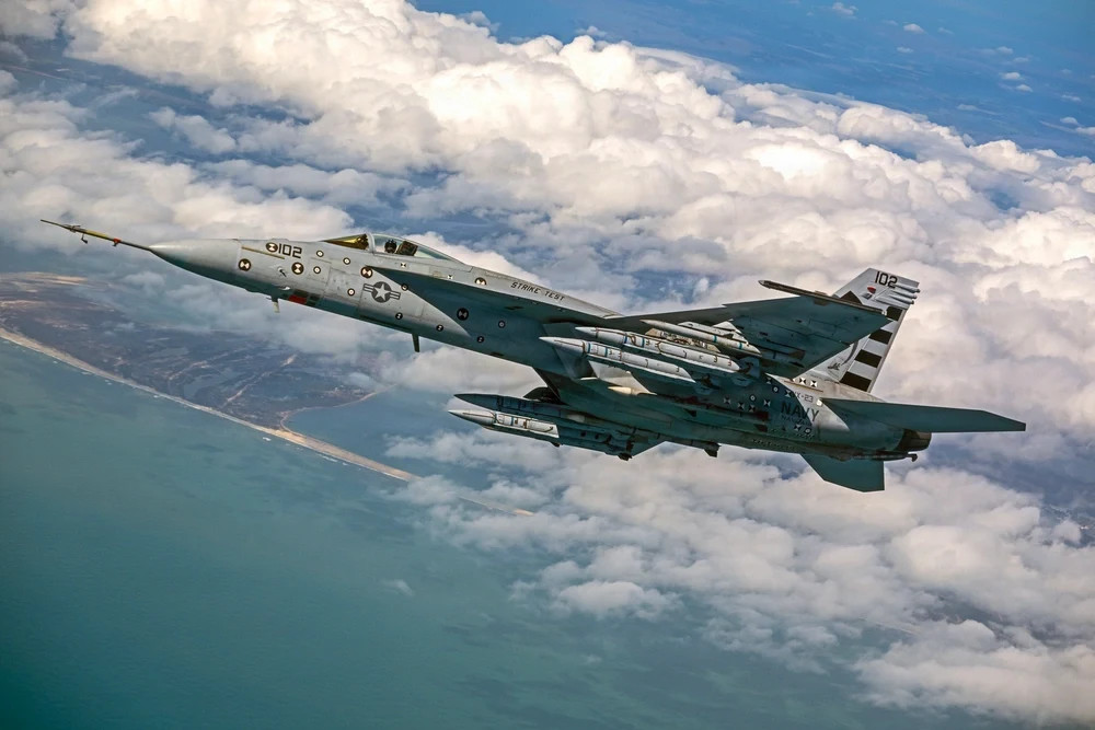 Four AIM-424 Long Range Air-to-Air Missiles (LRAAM) are loaded on an F/A-18E Super Hornet for a test event.