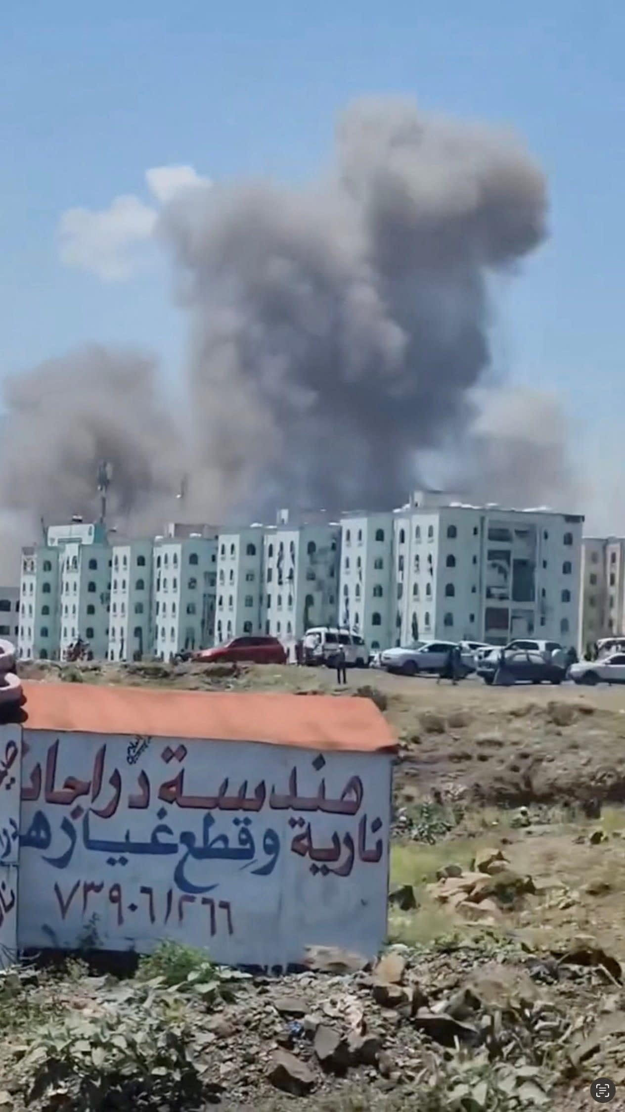 Smoke rises near buildings in Taiz Governorate, Yemen, following what the Houthi-run health ministry says was a strike on shops at a market, while Yemen's internationally recognised government says its forces targeted a Houthi military camp and vehicles at the same junction, September 27, 2026.