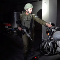  Israeli military spokesperson Rear Admiral Daniel Hagari points at a motorcycle with gunshot marks which he said appeared to have been used to bring hostages to Gaza after the surprise attack on October 7