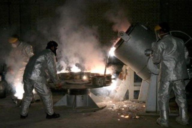 Iranian technicians work at a uranium processing site in Isfahan. (credit: REUTERS)