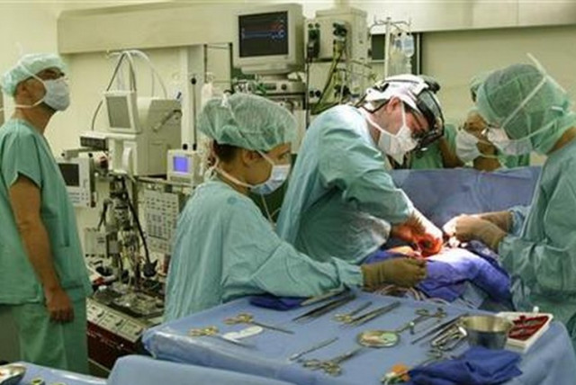 Doctors perform surgery [illustrative]. (credit: REUTERS)