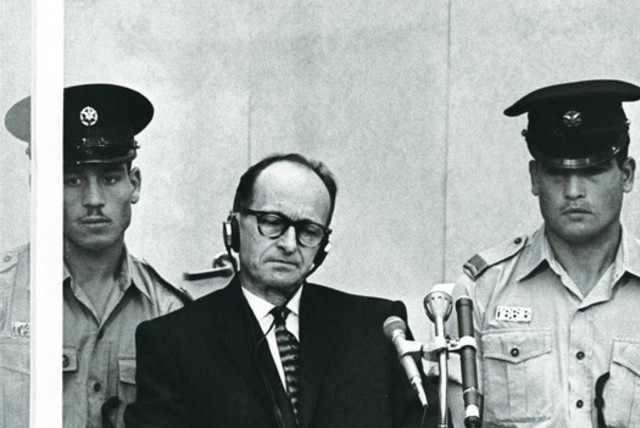 Adolf Eichmann sits during his trial in Jerusalem, 1961. (credit: REUTERS)