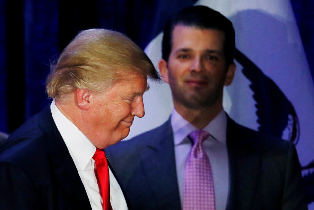 Donald Trump Jr. (R) watches his father Republican US presidential candidate Donald Trump leave the stage on the night of the Iowa Caucus (credit: JIM BOURG / REUTERS)