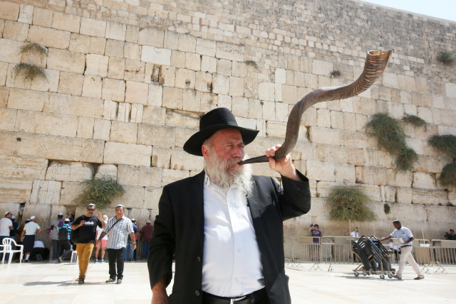 Man blowing the shofar at the Western Wall before Rosh Hashana (credit: MARC ISRAEL SELLEM)