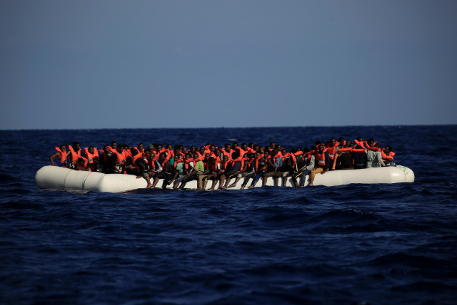 An overcrowded dinghy with migrants from different African countries is seen during a rescue operation off the Libyan coast in the Mediterranean Sea September 21, 2016. (credit: REUTERS)
