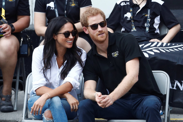 Britain's Prince Harry sits with fiance, actress Meghan Markle to watch a wheelchair tennis event during the Invictus Games (credit: MARK BLINCH/ REUTERS)