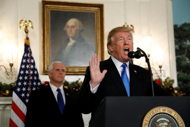 With Vice President Mike Pence looking on, US President Donald Trump gives a statement on Jerusalem, during which he recognized Jerusalem as the capital of Israel, in the Diplomatic Reception Room of the White House in Washington, US, December 6, 2017 (credit: REUTERS/KEVIN LAMARQUE)