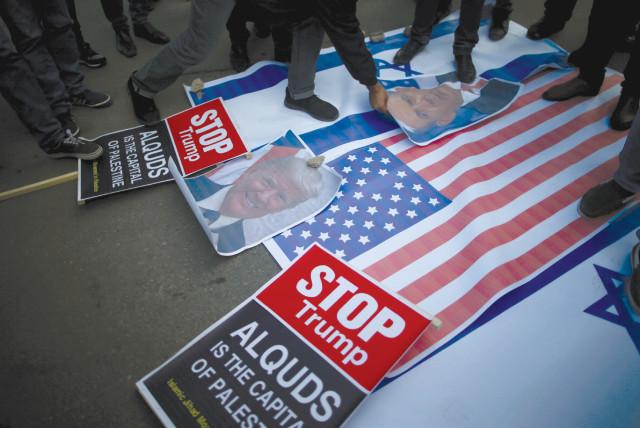 PROTESTERS IN Gaza City begin stomping on posters depicting Prime Minister Benjamin Netanyahu and US President Donald Trump and Israeli and American flags before burning them during a protest following Trump’s recognition of Jerusalem as the capital of Israel. (credit: MOHAMMED SALEM/REUTERS)