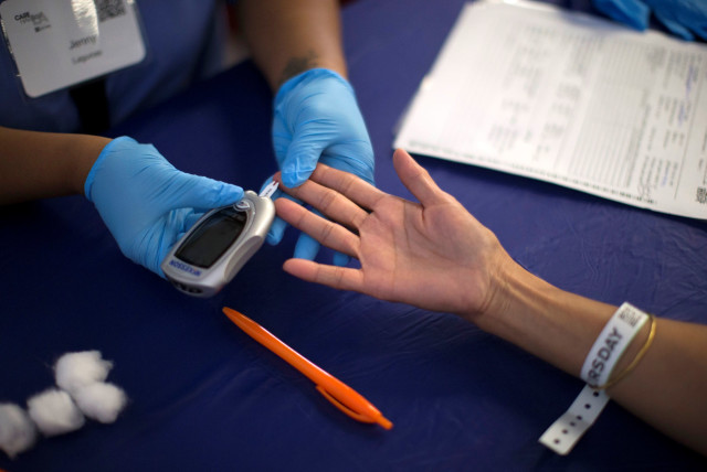 A person receives a test for diabetes during Care Harbor LA free medical clinic in Los Angeles, California September 11, 2014.  (credit: MARIO ANZUONI/REUTERS)