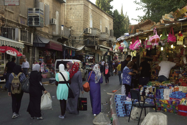 People shop on Salah a-Din Road near the Damascus Gate in east Jerusalem (credit: MARC ISRAEL SELLEM/THE JERUSALEM POST)