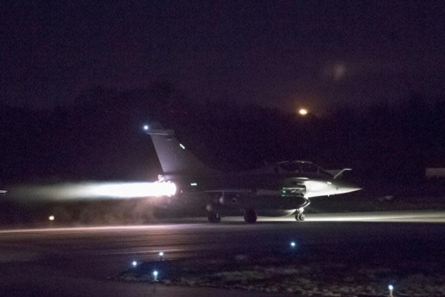 A plane preparing to take off as part of the joint airstrike operation by the British, French and US militaries in Syria, is seen in this picture obtained on April 14, 2018 via social media (credit: COURTESY FRENCH MILITARY/TWITTER/VIA REUTERS)