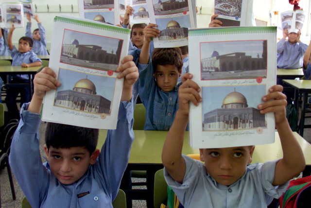 Palestinian students display their new Palestinian educational syllabus at the beginning of his new school year in Gaza Strip September 7, 2000 (credit: REUTERS)