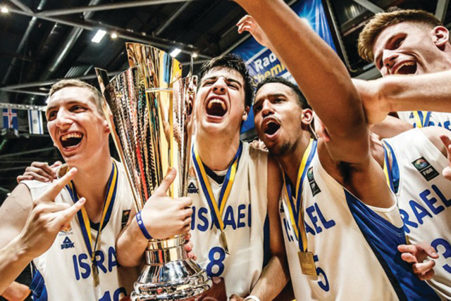 ISRAELI PLAYERS celebrate with the trophy on Sunday night following their 80-66 victory over Croatia in the final of the 2018 FIBA Under-20 European Championship in Chemnitz, Germany, a result that gave Israel its first-ever title at any major international basketball event at any national team leve (credit: FIBA EUROPE/ COURTESY)