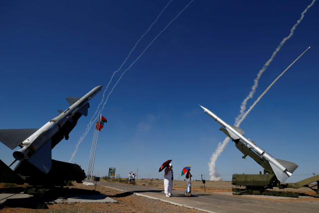 People watch S-300 air defense missile systems launching missiles during the Keys to the Sky competition at the International Army Games 2017 at the Ashuluk shooting range outside Astrakhan, Russia, August 5, 2017.  (credit: REUTERS/MAXIM SHEMETOV)