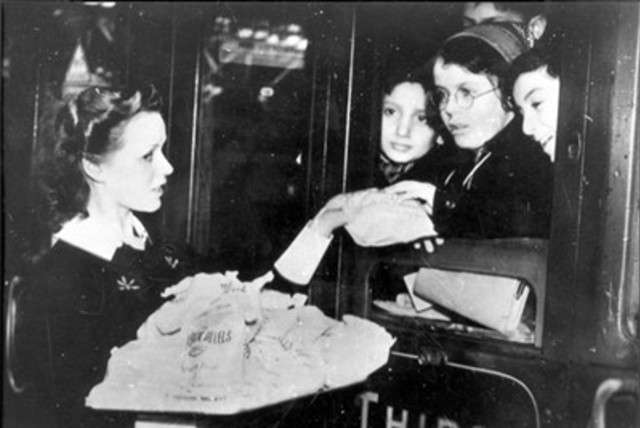 Children evacuated from Germany on the Kindertransport in 1938/1939 are given candies in Southampton, England (credit: MAARIV)