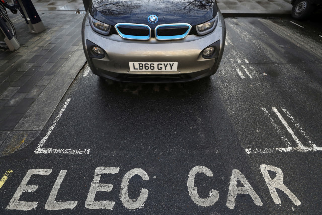 A car is parked at a charging point for electric vehicles in London, Britain, March 6, 2018. (credit: REUTERS/SIMON DAWSON)