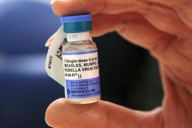 A nurse holds a vial of measles, mumps and rubella vaccine (credit: REUTERS/BRIAN SNYDER)