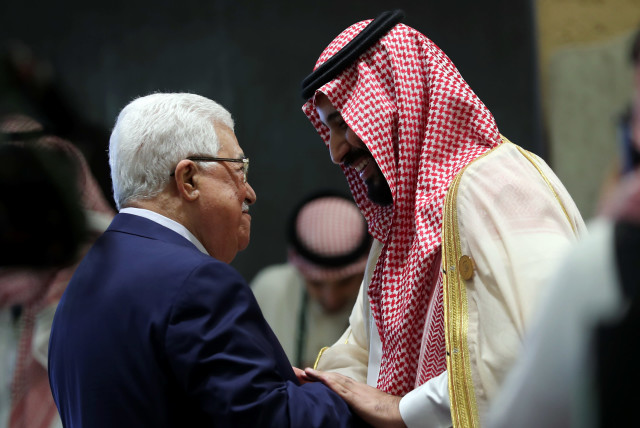 Saudi Arabia's Crown Prince Mohammed bin Salman greets Palestinian President Mahmoud Abbas before the start of the 29th Arab Summit in Dhahran, Saudi Arabia April 15, 2018 (credit: HAMAD I MOHAMMED/REUTERS)