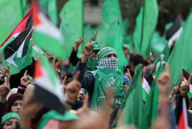 Palestinians take part in a rally marking the 31st anniversary of Hamas' founding, in Gaza City (credit: IBRAHEEM ABU MUSTAFA / REUTERS)