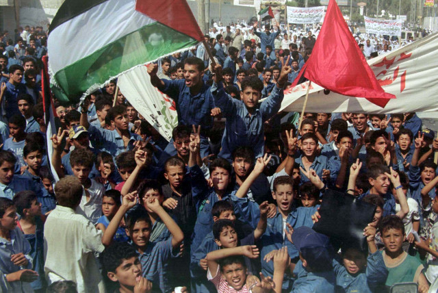 Palestinian school children chant slogans during a demonstration August 28 1997 in the Gaza Strip protesting spending cuts by UNWRA.  (credit: REUTERS)