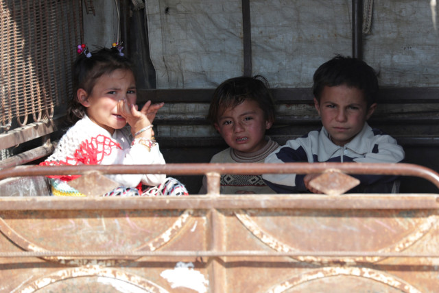 Children sit in an auto rickshaw in Tal Abyad, one of the cities in which Turkish President Tayyip Erdogan plans to resettle Syrian refugees (credit: KHALIL ASHAWI / REUTERS)